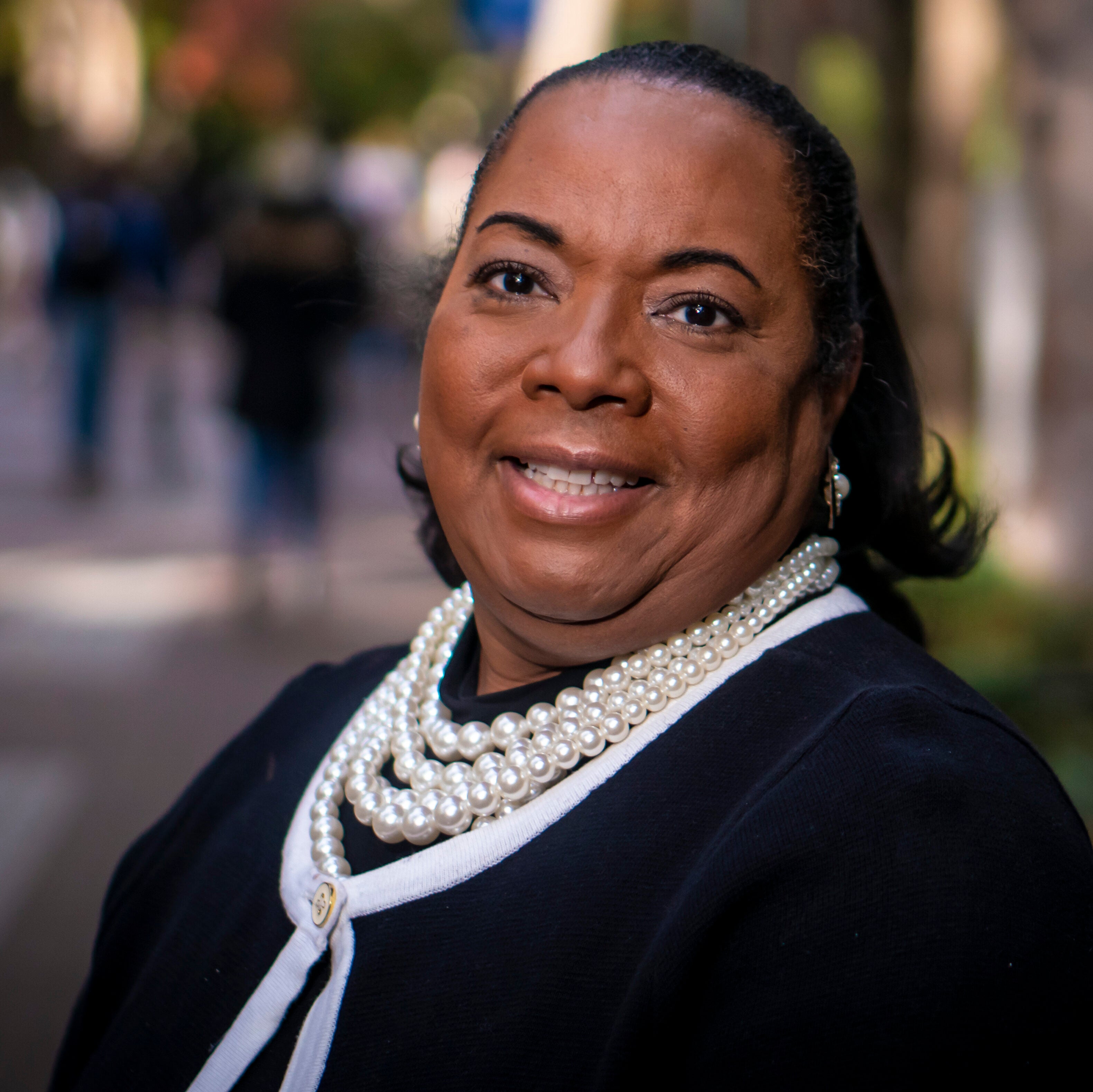 Tamara Greenfield King stands in front of Locust Walk on a Fall day