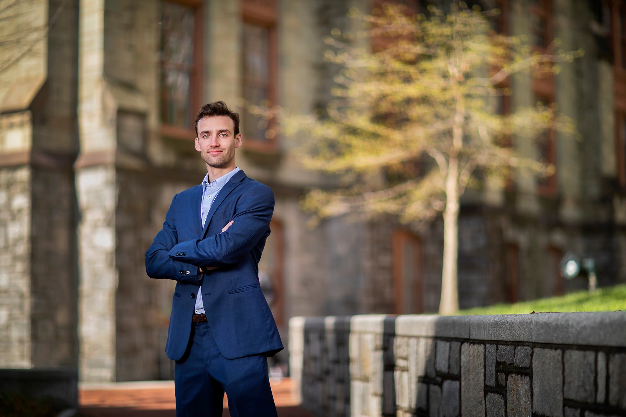 Sam Strickberger stands outside on College Green on Penn's campus