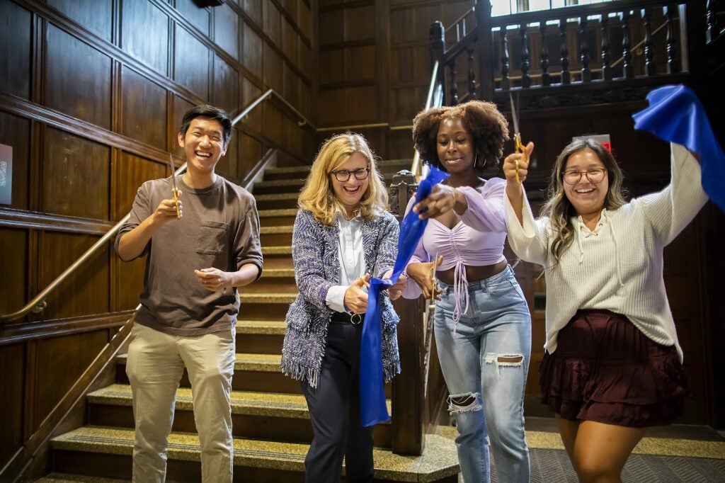 Jeffrey Yu, President Magill, Taussia Boadi, and Elizabeth Ramos cut the ribbon to celebrate the reopening of the ARCH building with cultural resource centers and affiliated groups, many of which were formerly housed at the garden level, now having full use of the building.