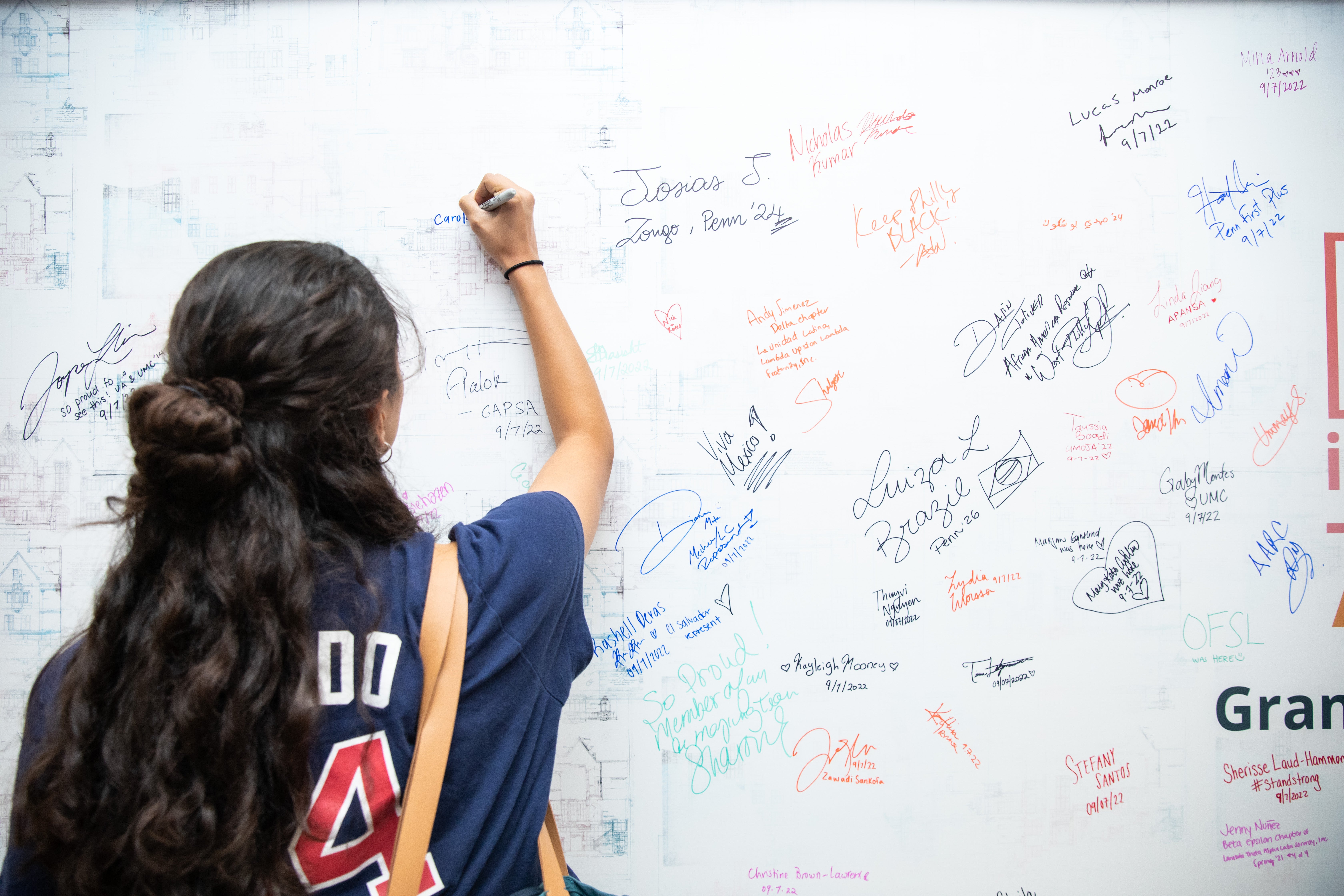Penn student signs the ARCH Reimagine wall_4