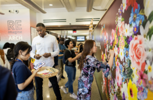 Penn community adding flowers to the APA Heritage mural in the ARCH