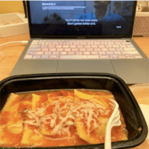 A plate of food in front of a laptop