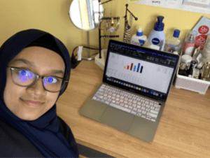 Maliha Rhaman in front of a laptop