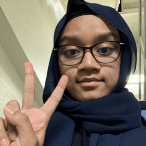 Maliha Rhaman giving a peace symbol