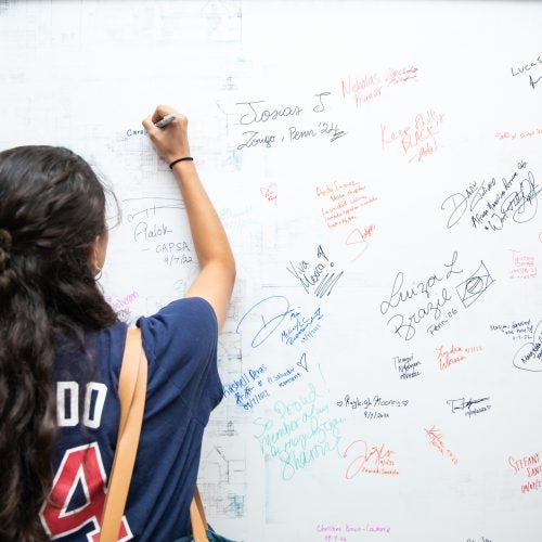 Penn student signs the ARCH Reimagine wall_4
